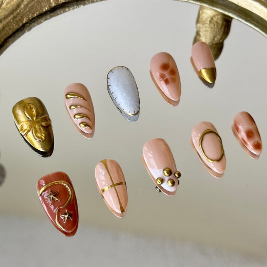 Close-up of the intricate brown floral marble and tortoise-shell patterns on the pinky by MYOB Nails.