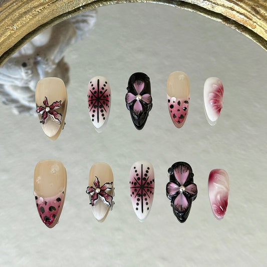 Front view of Dusk Orchid nails showing the cherry red and black tones with handcrafted 3D floral artistry.