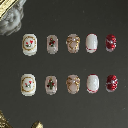 christmas themed presson nails with gold bows, chrismas trees and snowflake