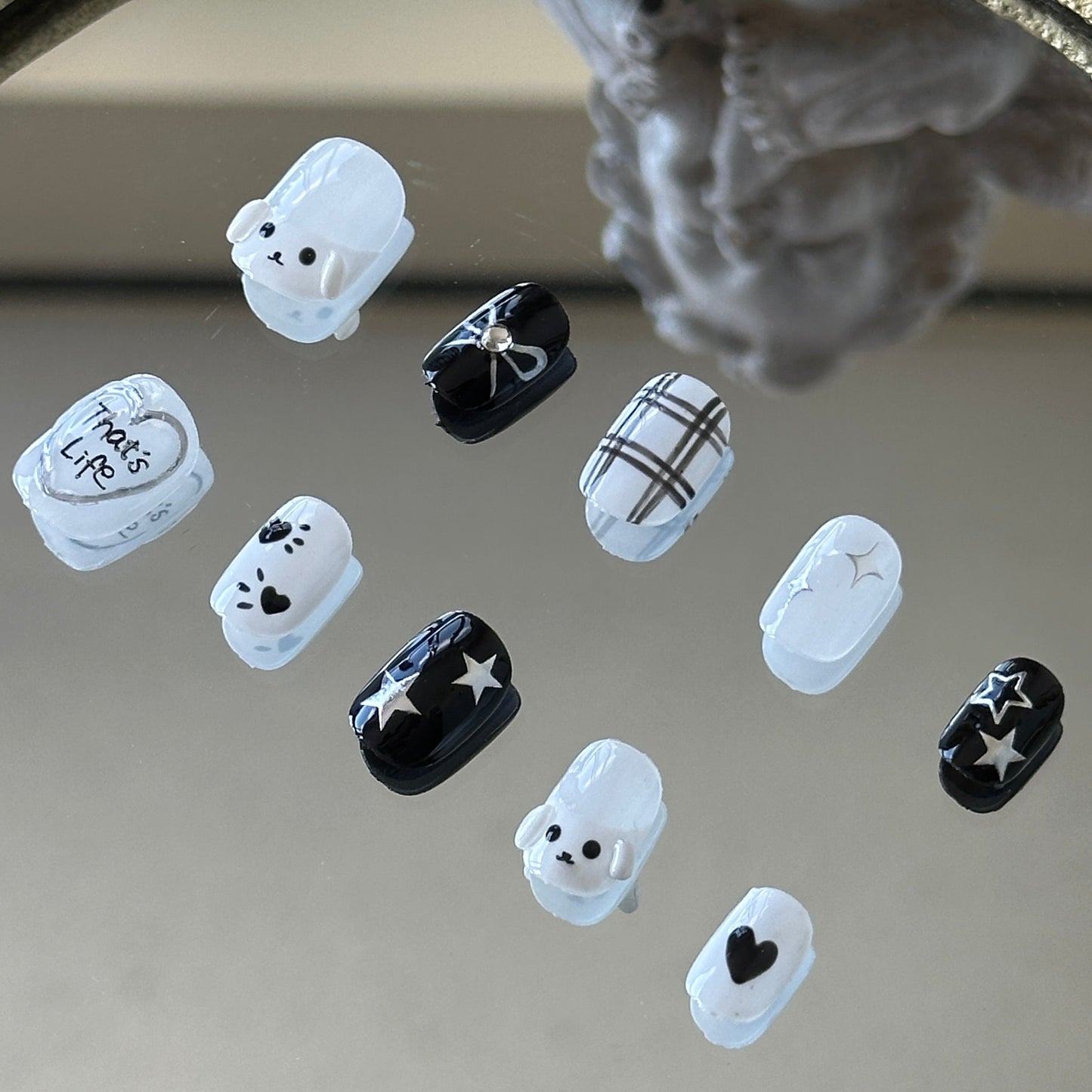 Right side view of MYOB Nails press-on nails showing the silver metallic "That's Life" heart design and delicate twinkling star illustrations.