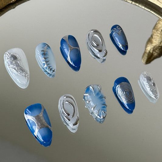 Close-up of the misty blue marble and subtle silver cat-eye shimmer by MYOB Nails.