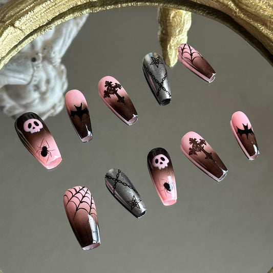 Left side detail of MYOB Nails Pink Abyss set highlighting the hand-painted pink skull and intricate black spiderweb motifs.
