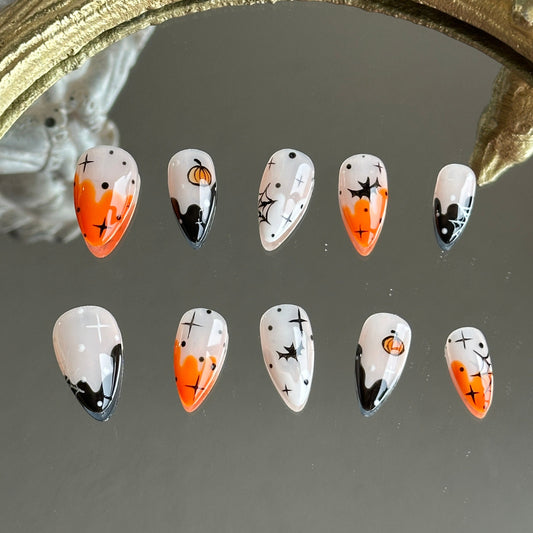 Front view of Pumpkin Spell handmade press-on nails by MYOB Nails featuring orange and black ombre with hand-painted pumpkins and bats.