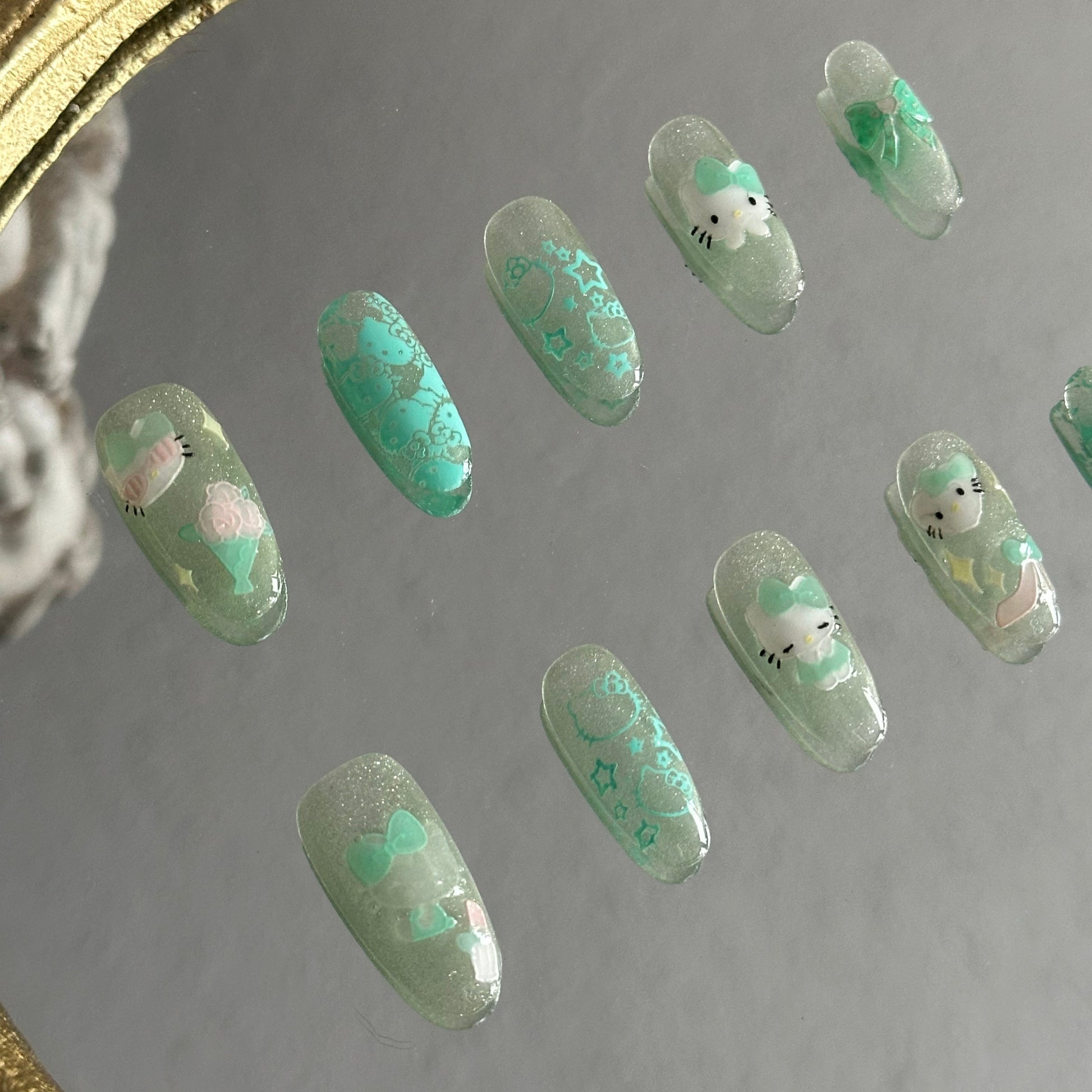 mint Kitty bow embossed stickers green cat-eye nails detail