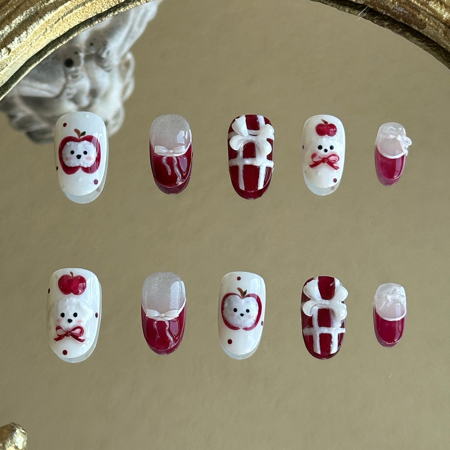 Front view of Apple Puppy handmade press-on nails by MYOB Nails featuring red plaid, cute apple puppy art, and 3D ribbon accents.