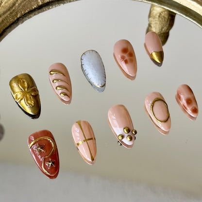 Close-up of the intricate brown floral marble and tortoise-shell patterns on the pinky by MYOB Nails.