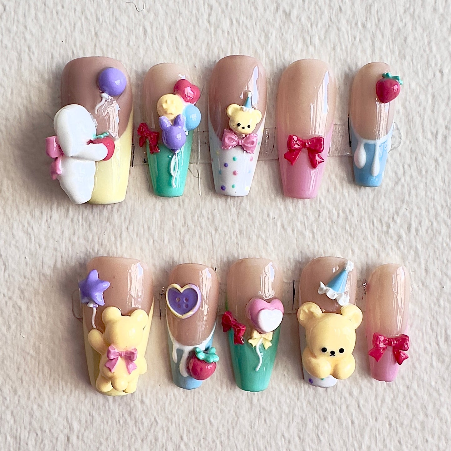 Front view of Bearthday Party nails showing the vibrant pastel French tips and playful 3D characters.