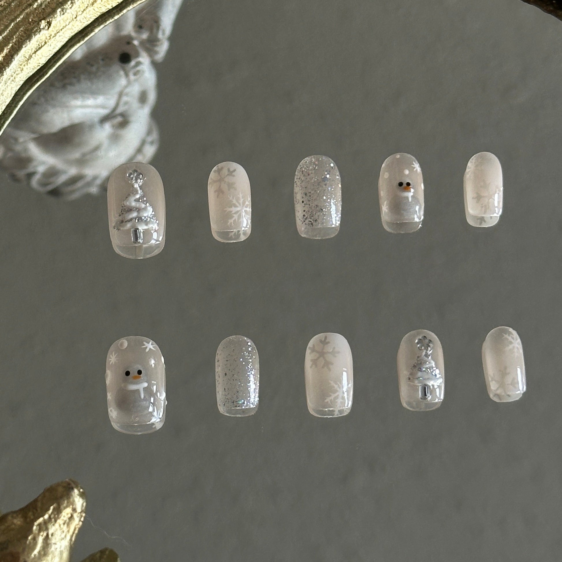 cateye and gitter based christmas nail set wih christmas tree, snowman and snowflakes. 