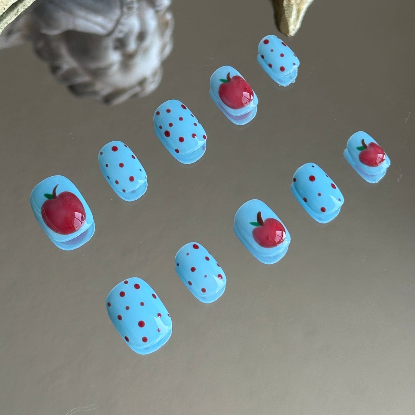 Close-up detail of the 3D apple art with raised transparent glaze for a juicy, sculpted effect by MYOB Nails.