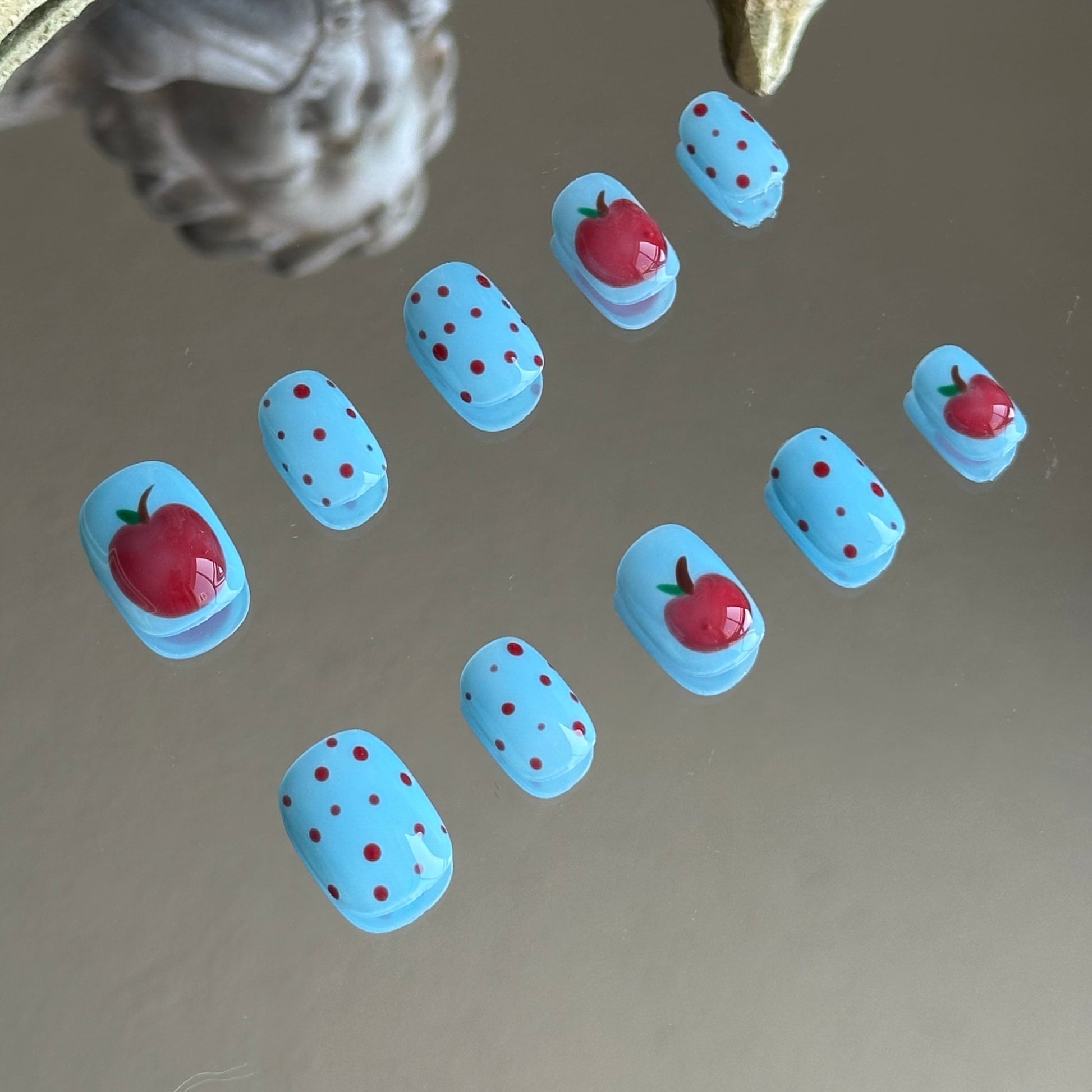 Close-up detail of the 3D apple art with raised transparent glaze for a juicy, sculpted effect by MYOB Nails.