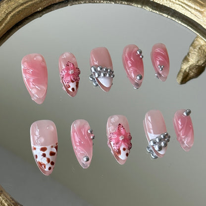 Close-up of the 3D pink sculpted flowers with brown dots and coordinated leopard print accents by MYOB Nails.