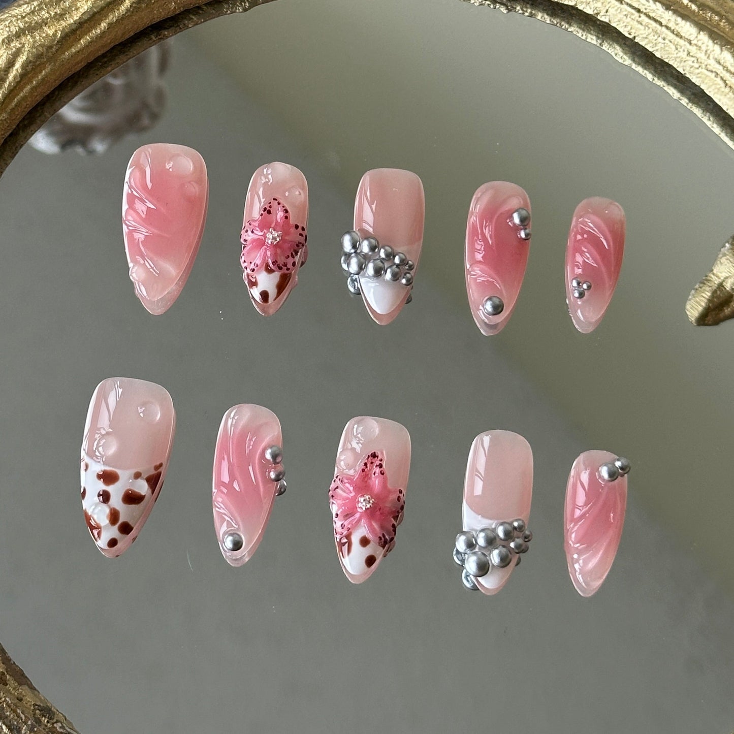 Front view of Bloomwild nails showing the nude base, pink blush smudging, and hand-painted leopard French tips.