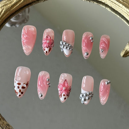 Front view of Bloomwild nails showing the nude base, pink blush smudging, and hand-painted leopard French tips.
