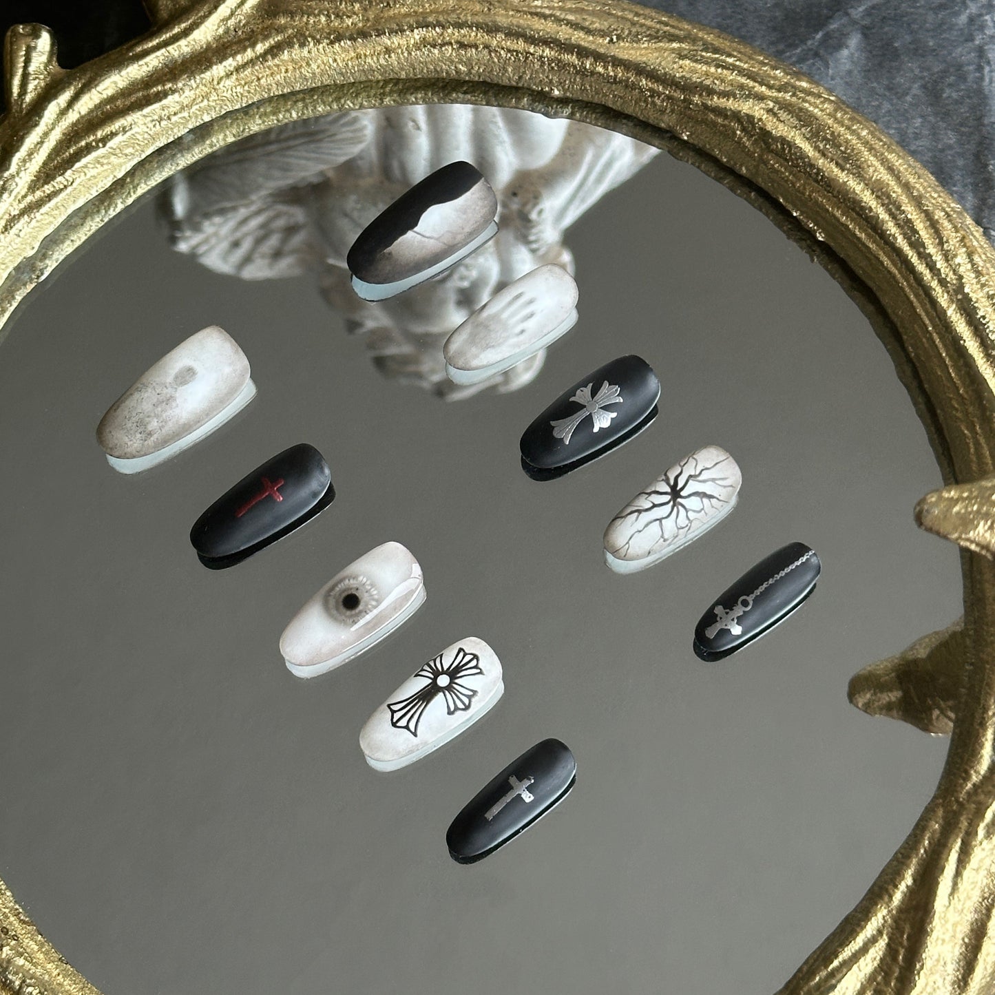 Right side view of Blur nails by MYOB Nails highlighting the ghostly handprint and silver gothic cross design.