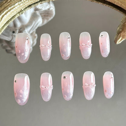 Front view of Bow Me Softly handmade nails showing pink blush centers, purple cat-eye tips, and pearl French lines.