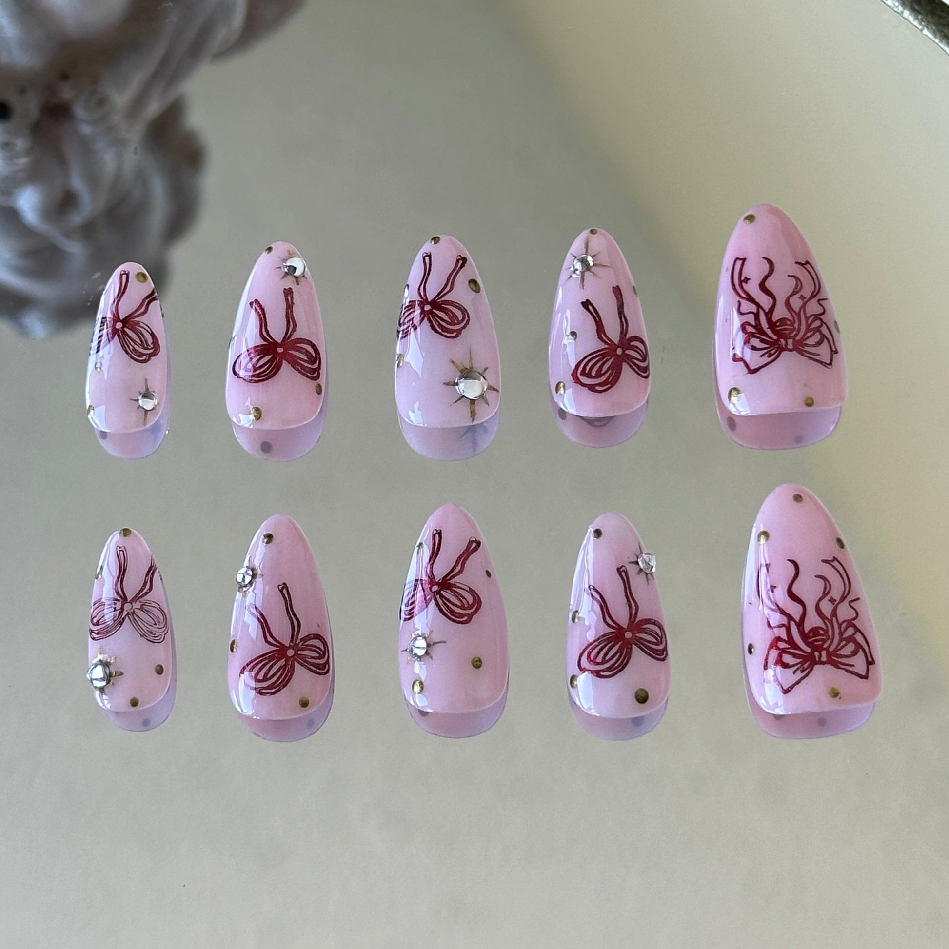 Back view showcasing the elegant almond shape and the glossy pink finish of the Bowberry set.