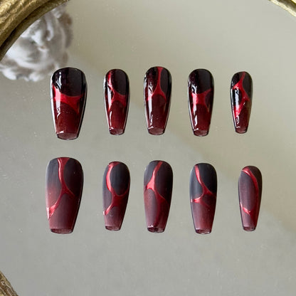 Front view of Burn nails showcasing the full glossy finish and full matte finish options on a red-black gradient.