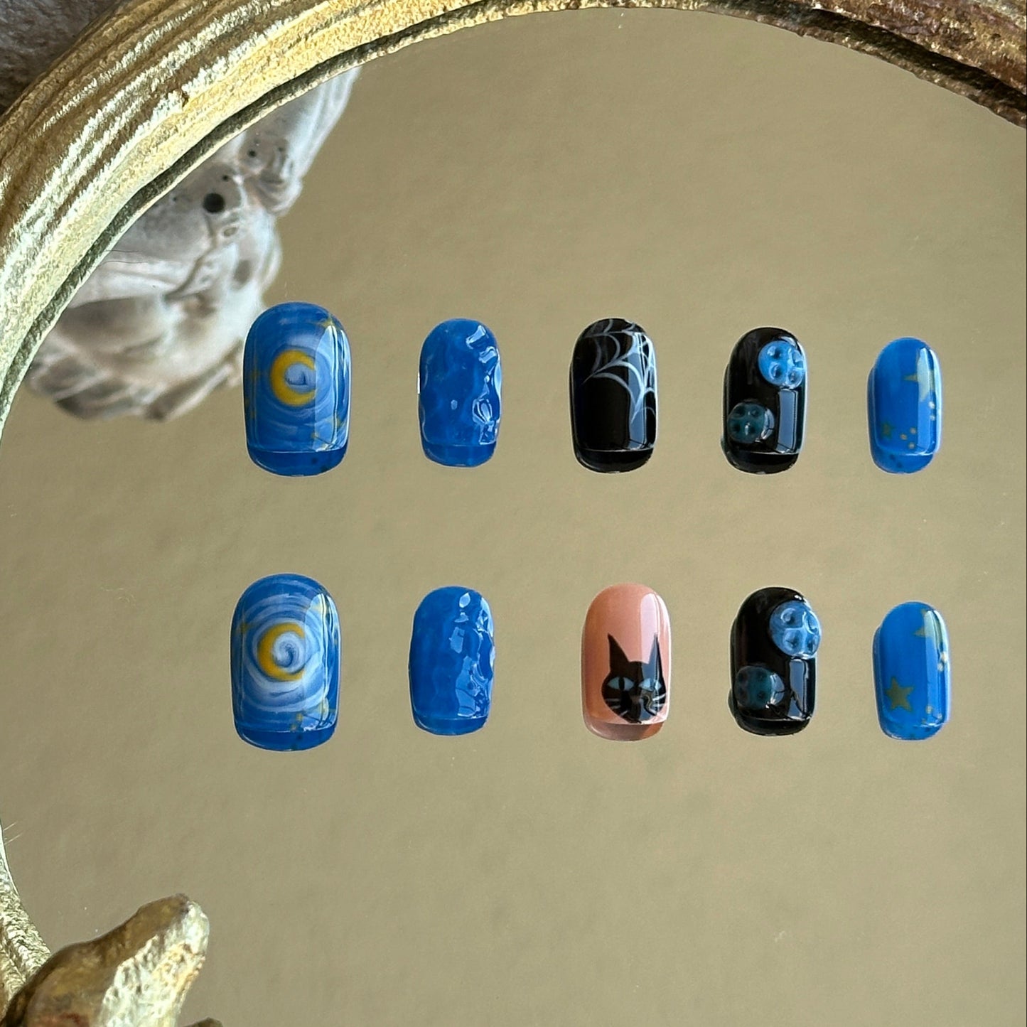 blue black and beige nail set with moon, cat and buttons