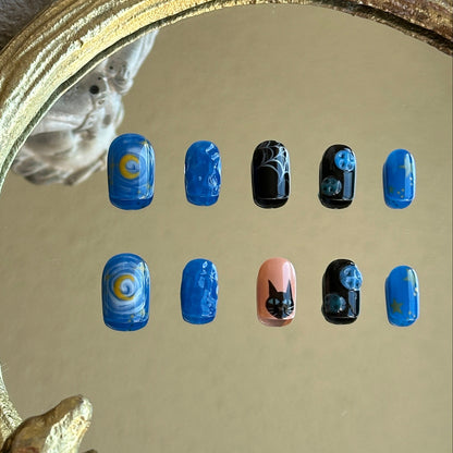 blue black and beige nail set with moon, cat and buttons