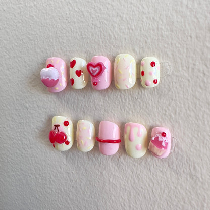 Side view highlighting the textured 3D candy elements and playful heart-shaped lollipop designs.