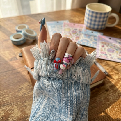 Hand modeling the Cozy Cowgirl nails by MYOB Nails, highlighting the eclectic mix of red, blue, and 3D star charms for a rugged yet sweet look.