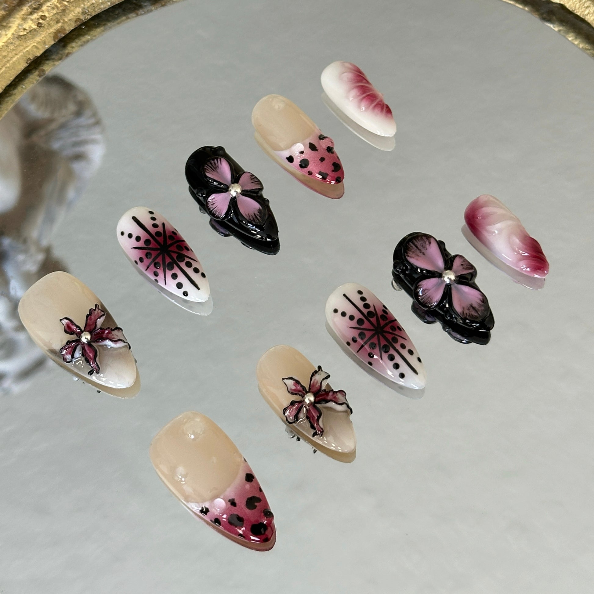 A close-up of the 3D sculpted cherry red orchids and the soft smoky gradient on a sheer base.