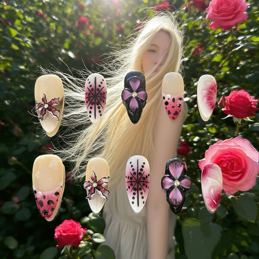 Handmade Dusk Orchid press-on nails featuring 3D floral accents, black and pink gradient patterns, and leopard print details on almond-shaped tips.