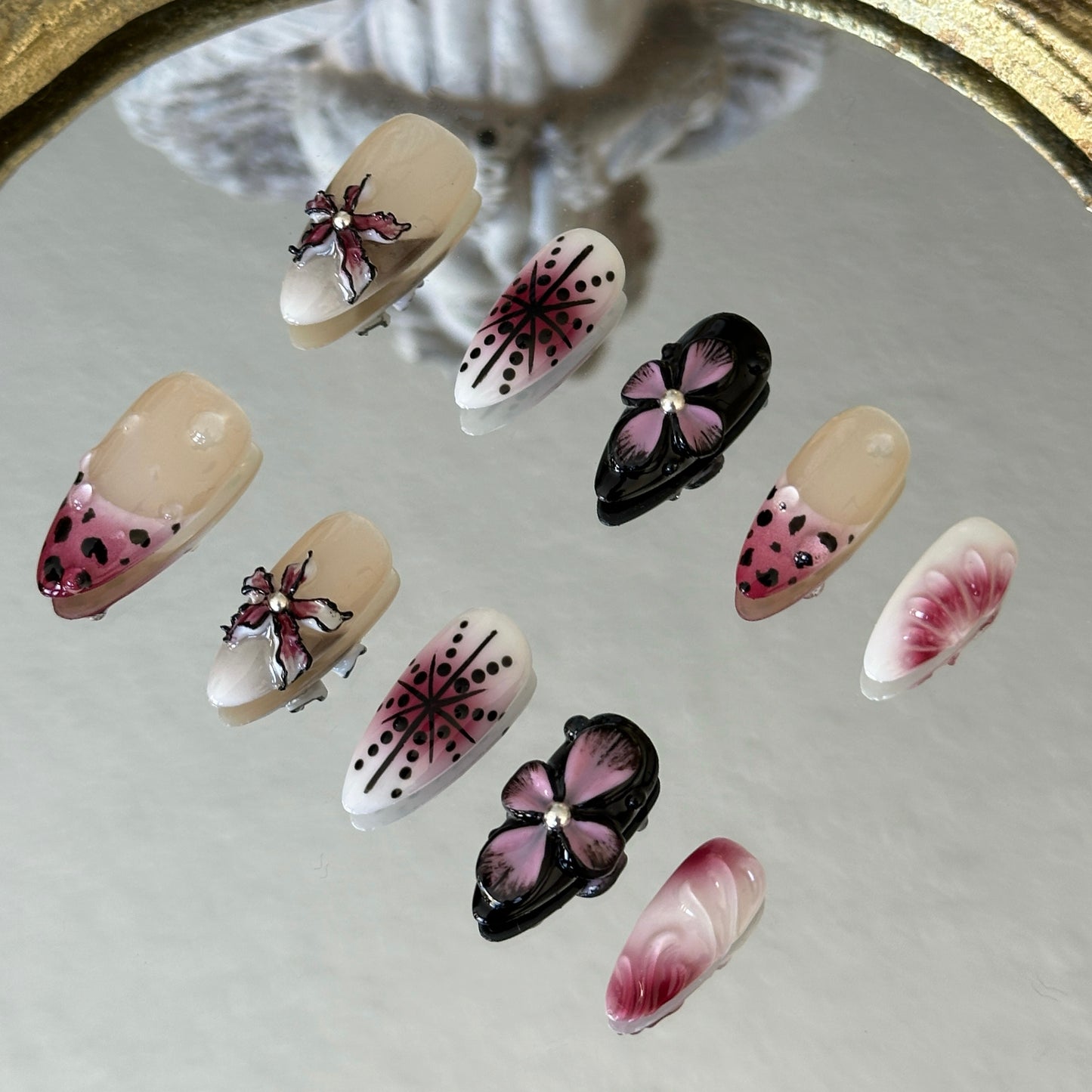 Side view highlighting the symmetrical star patterns and the edgy black-and-cherry-red leopard print tips.