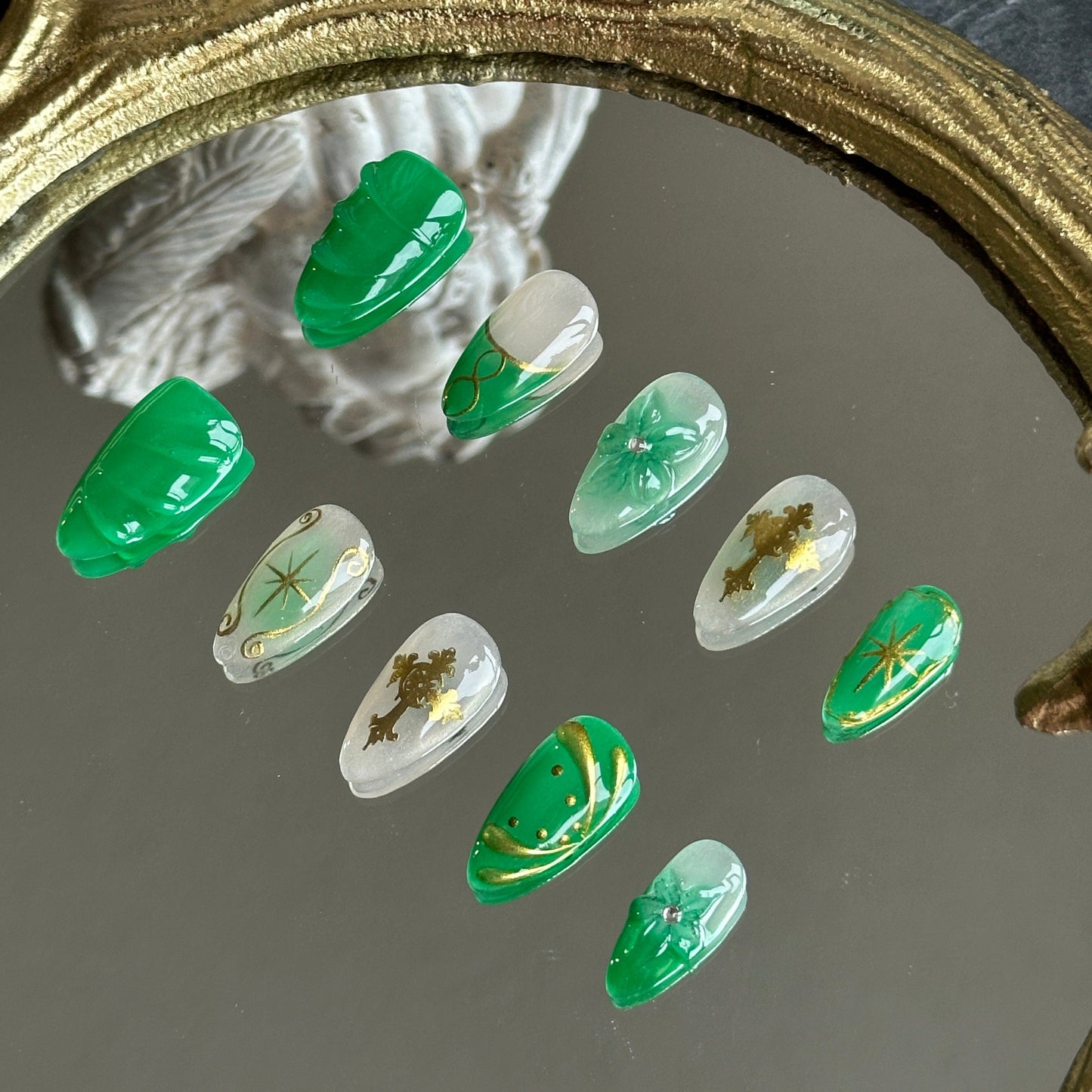 Right side view of Emerald Sigil nails by MYOB Nails showing the high-relief 3D gold cross and delicate floral scrollwork.