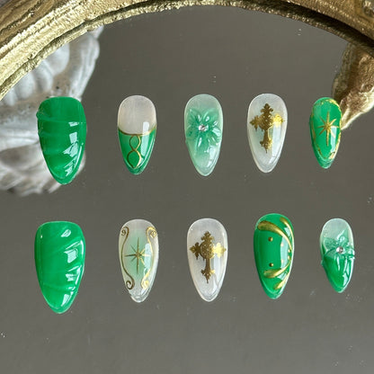 Front view of Emerald Sigil handmade press-on nails by MYOB Nails featuring emerald green swirls with gold crosses and baroque art.