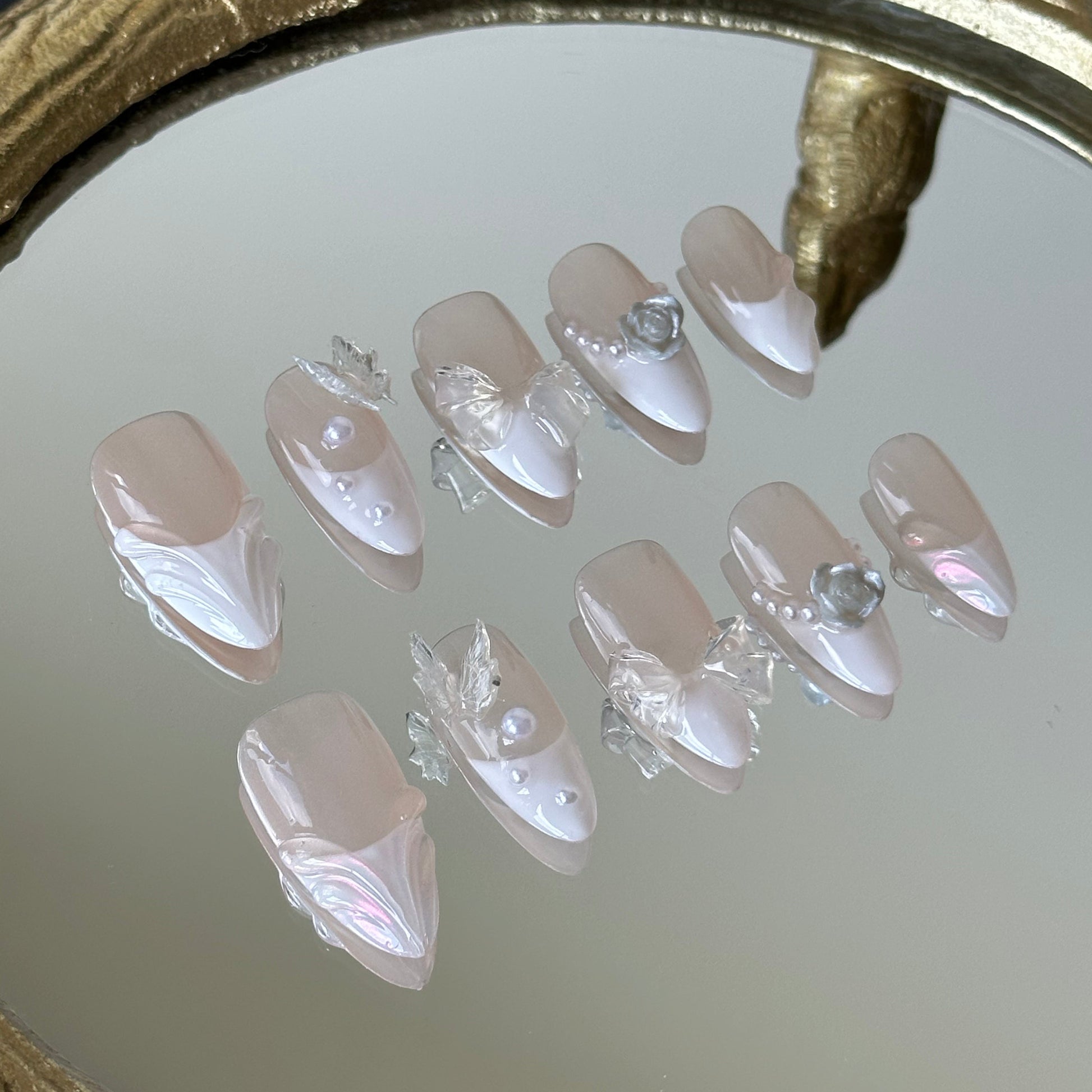 Close-up detail of 3D transparent butterflies and sculpted water ripple lines by MYOB Nails.