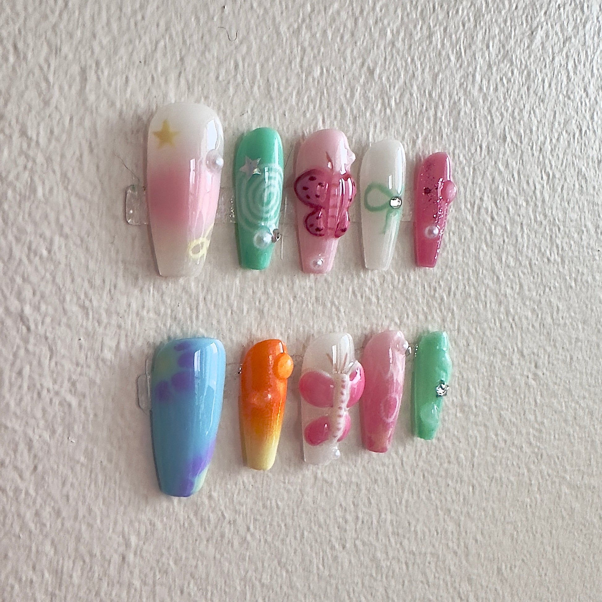 Detailed shot of the multi-layered 3D hand-sculpted butterflies set against a soft, shimmering gradient base.