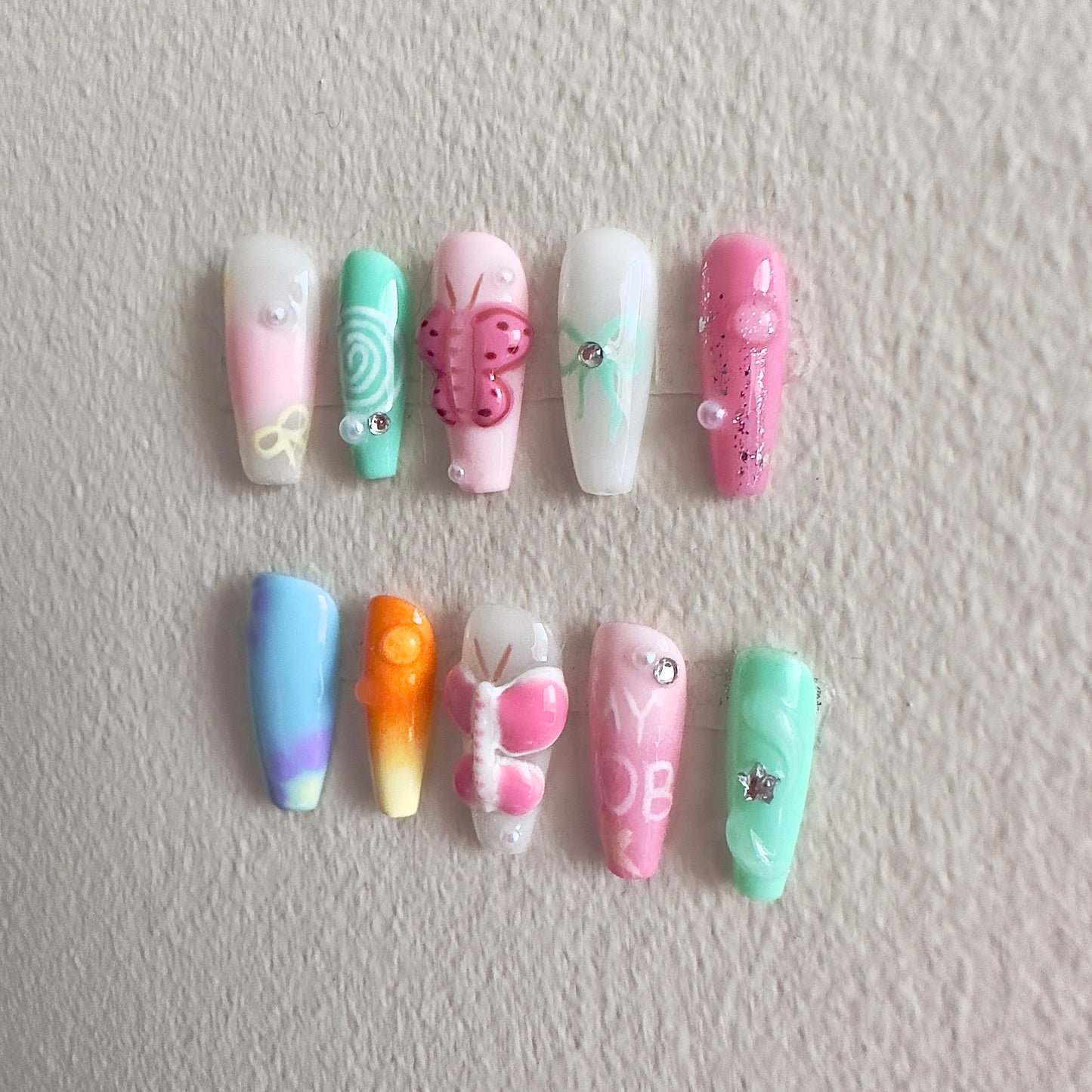 Side view highlighting the delicate hand-painted swirls, bows, and realistic 3D water drop textures.