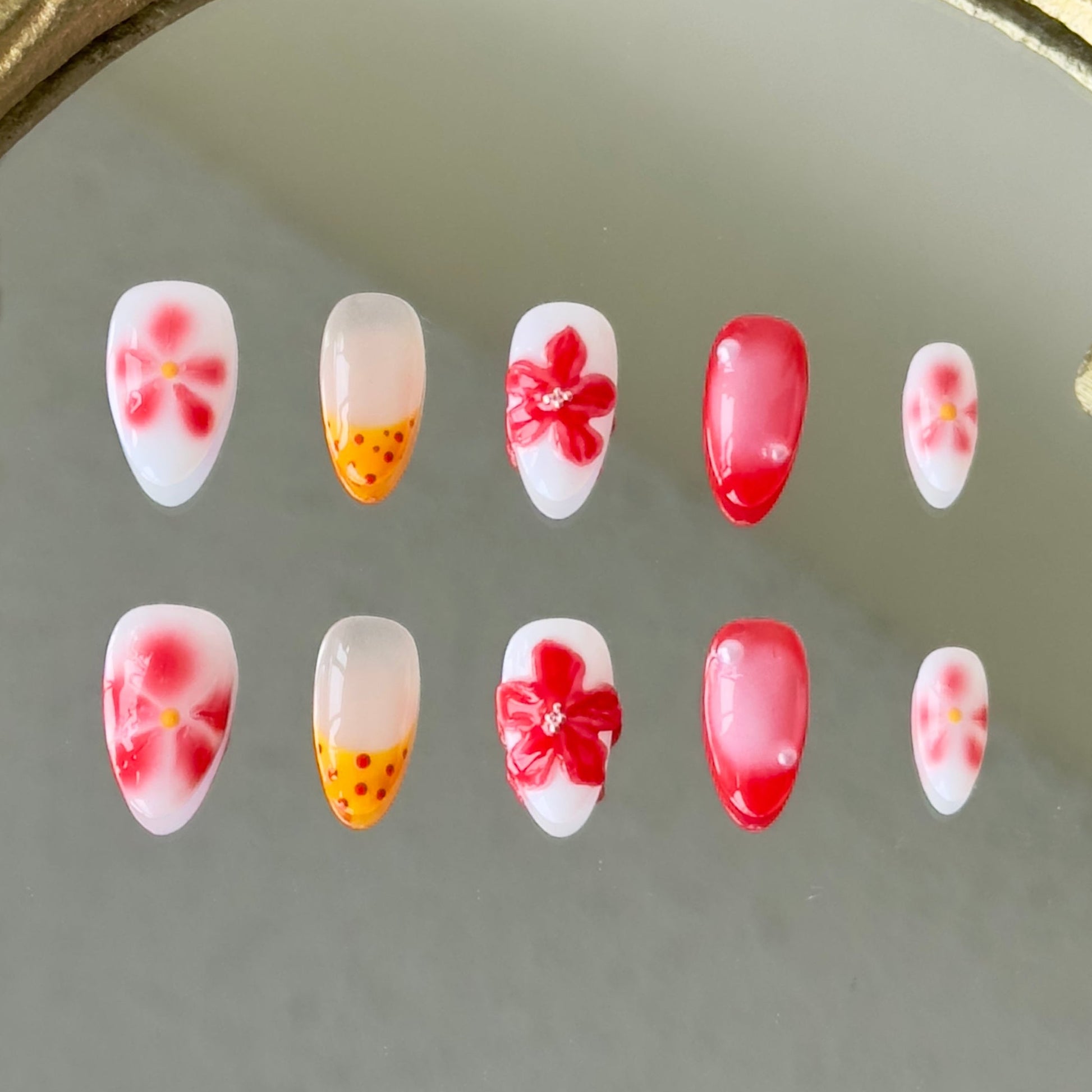 Front view of Flamekissed nails showing the red ombre, yellow French tips, and delicate hand-painted details.