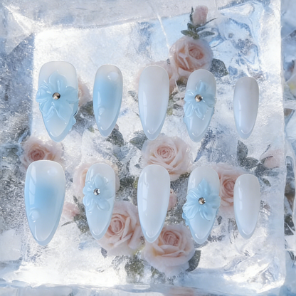 Frozen Petals by MYOB Nails featuring 3D blue flowers encapsulated in a clear ice-like layer.