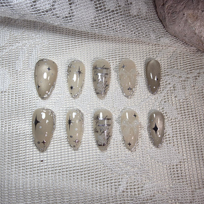 A complete overhead view of the Galactic Poetry set, showing the balanced celestial art on a shimmering beige cat-eye base.
