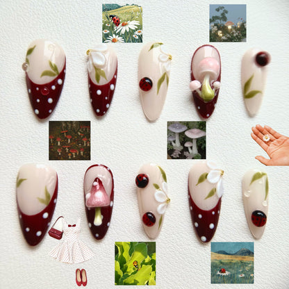 Front view of A Glimpse of the Forest nails showing the hand-painted polka dots and delicate white floral accents.