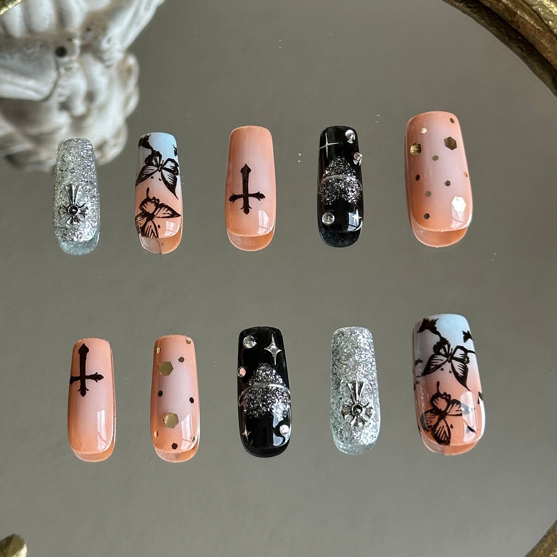 Back view of the Gothic Flutter handcrafted nail set by MYOB Nails, showcasing a perfect blend of feminine pink and gothic black.