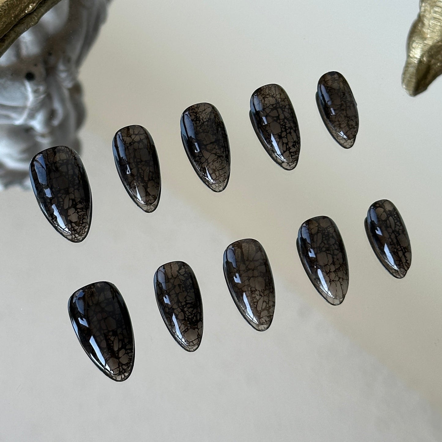 Close-up detail of the delicate black lace patterns peek-a-boo effect by MYOB Nails.