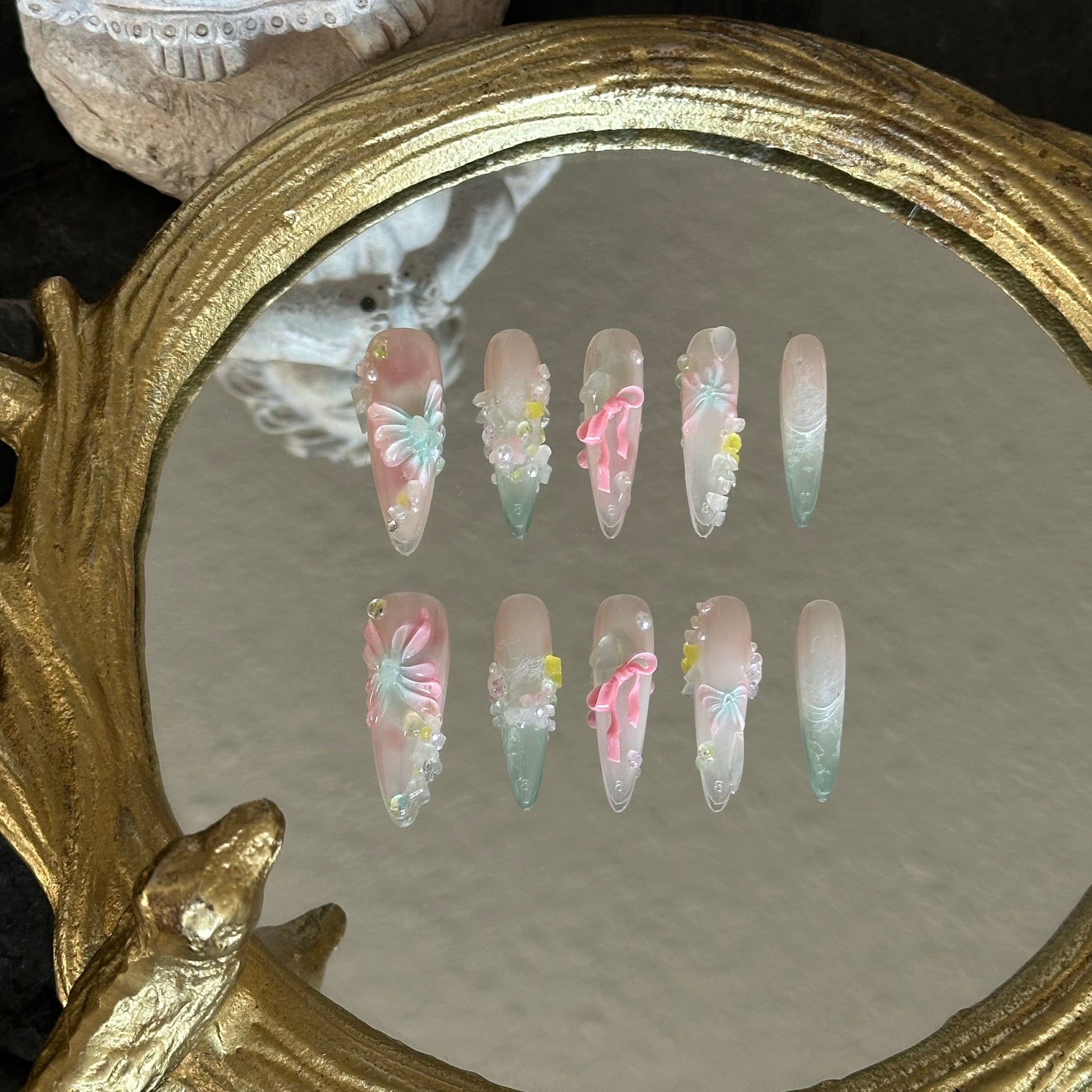 Front view of A Letter from Spring nails showcasing the sheer, jelly-like quality, glitter 'gravel' texture, and 3D floral accents.