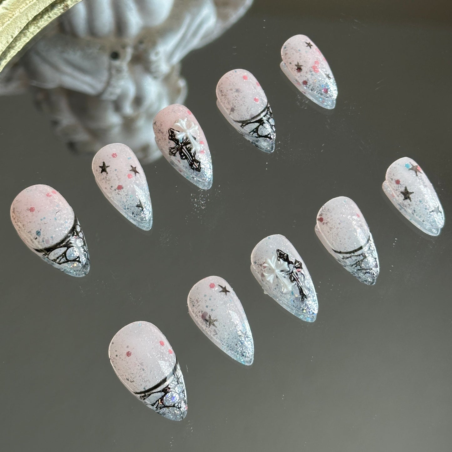 Left side detail of the nails highlighting the delicate hand-painted black lace hollow French tips.