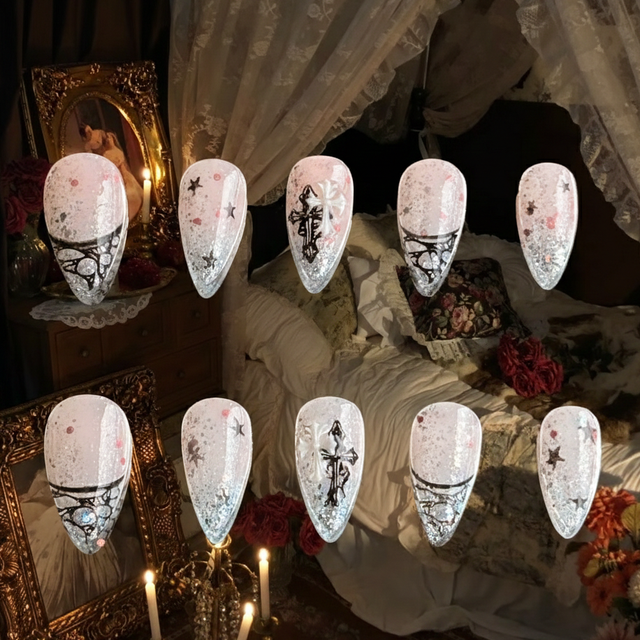 Lunar Veil nails by MYOB Nails featuring black lace French tips and 3D cross charms on a glittery nude gradient.