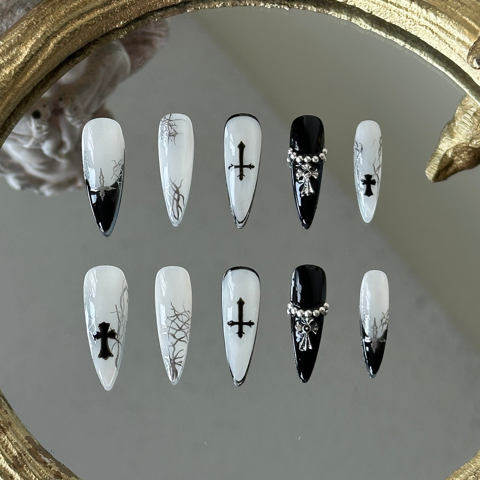 Front view of Luxthorn handmade nails with black French tips, full black rims, and metallic silver accents.