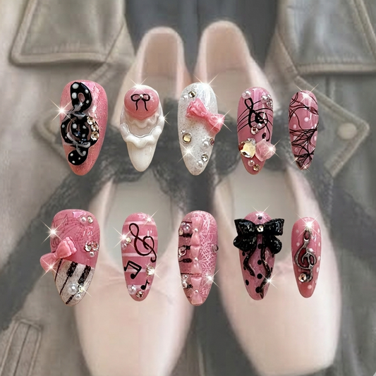 Melody Muse press-on nails by MYOB Nails featuring pink glitter bases, 3D black musical notes, and delicate pink bows.