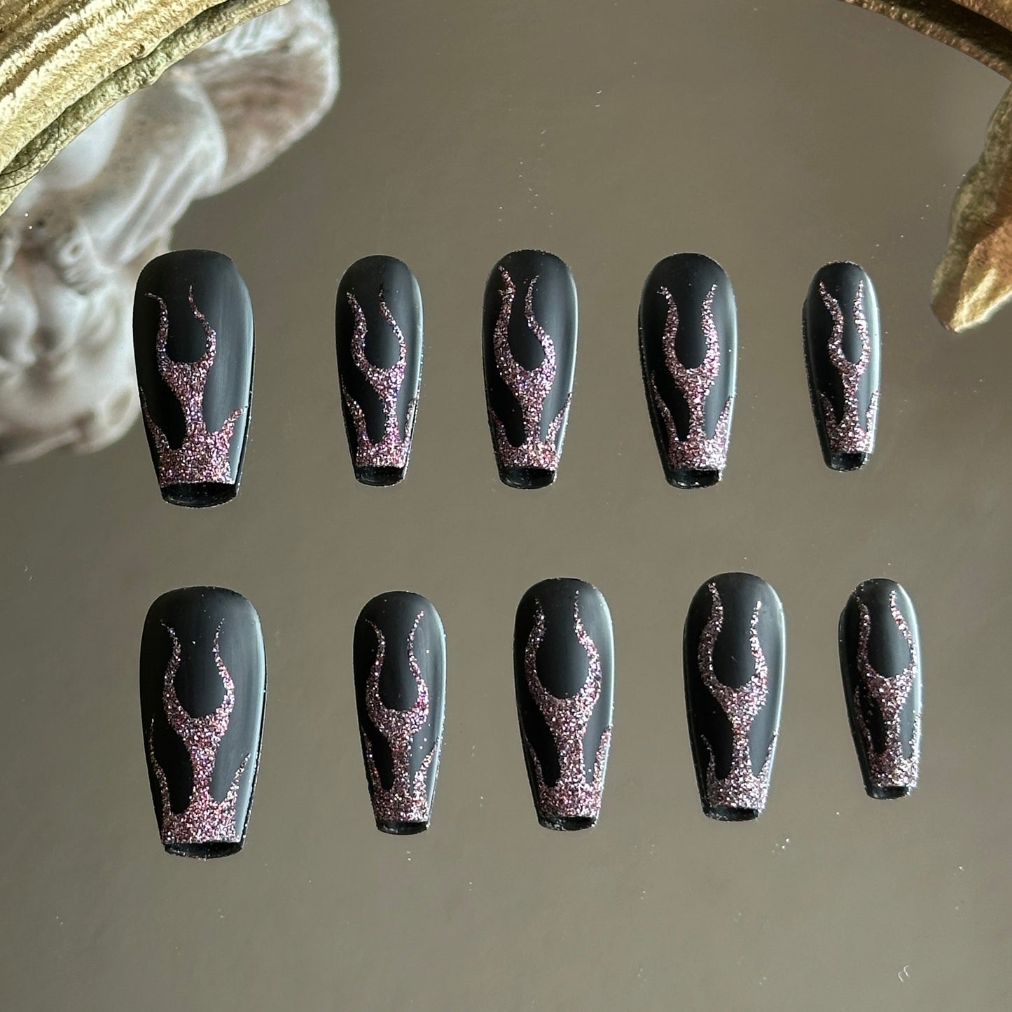 Front view of Midnight Blaze handmade nails showing the high-contrast red glitter fire art on matte black tips.