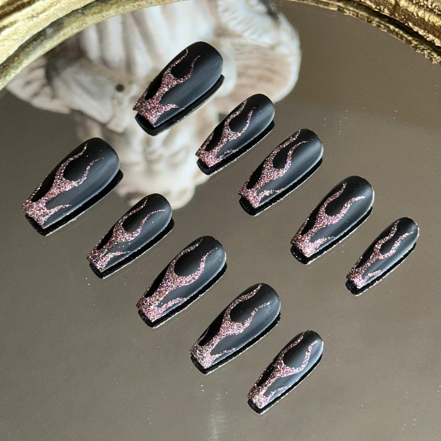 Side view showing the velvet-like matte black finish contrasting with the shimmering red flame art.