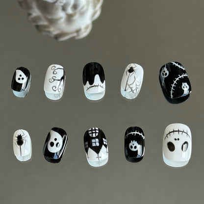 Back view of the Midnight Masquerade handcrafted nail set by MYOB Nails, showcasing a playful and ghostly black-and-white cartoon aesthetic.