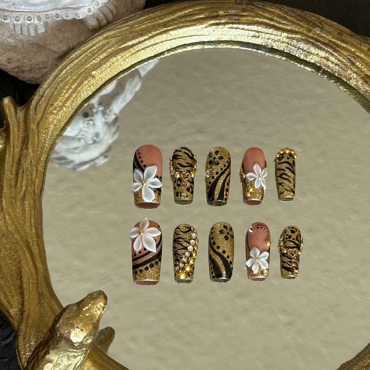 Front view of Millennium Disco nails showing the bold combination of gold sequins, animal patterns, and pearl accents.