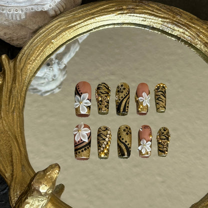 Front view of Millennium Disco nails showing the bold combination of gold sequins, animal patterns, and pearl accents.