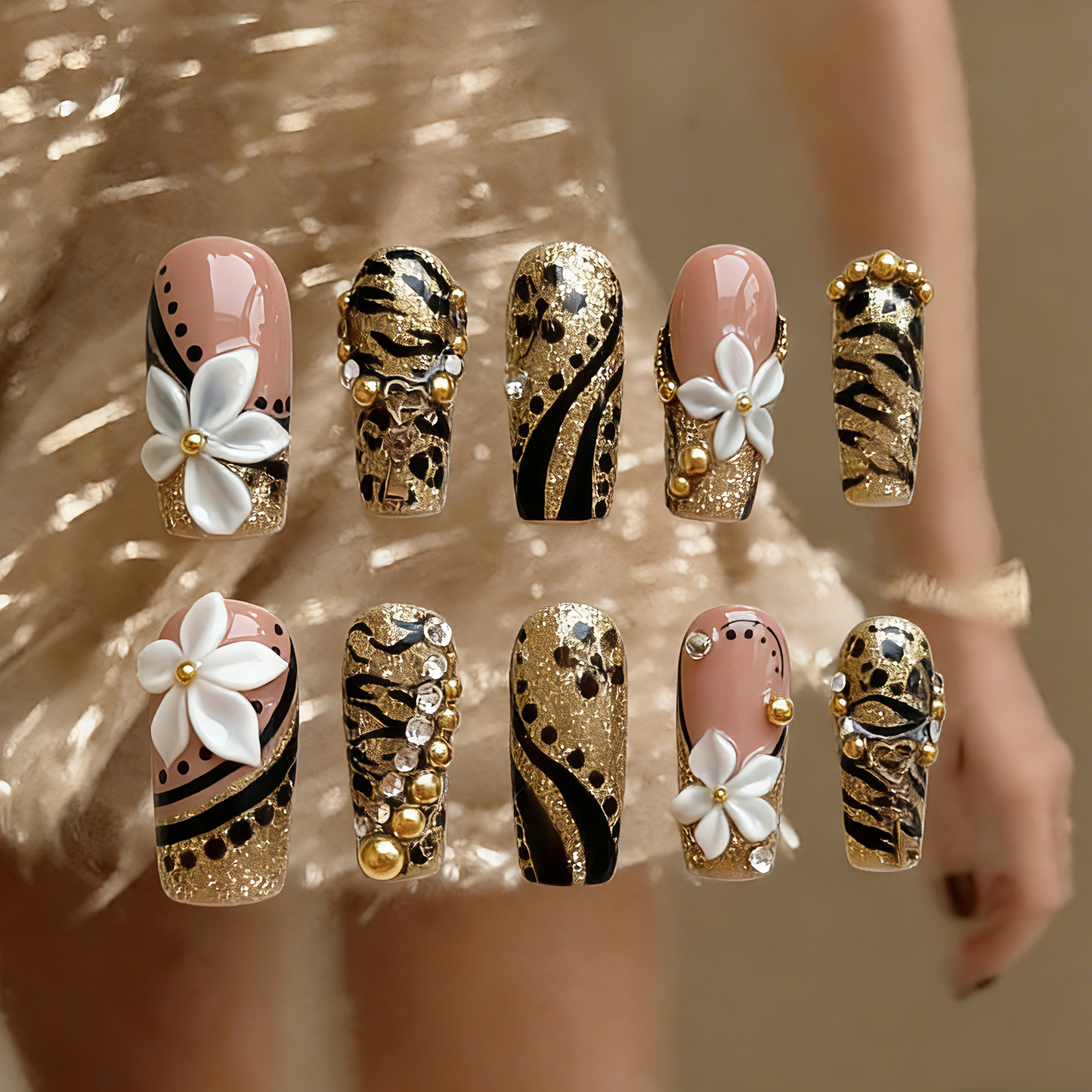 Millennium Disco press-on nails by MYOB Nails featuring gold glitter, hand-painted leopard and tiger prints, and 3D white flowers.